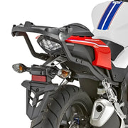 Rear view of white red black motorcycle with matte black luggage mounting hardware
