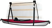 Red and white marine kayak hoist hanging from a boat hoist setup
