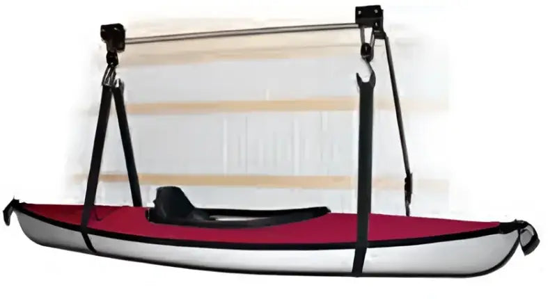 Red and white marine kayak hoist hanging from a boat hoist setup
