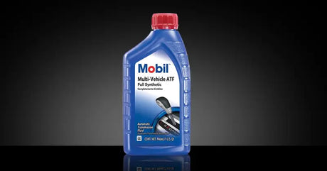 Mobil Multi-Vehicle ATF Full Synthetic transmission fluid bottle on a dark background.