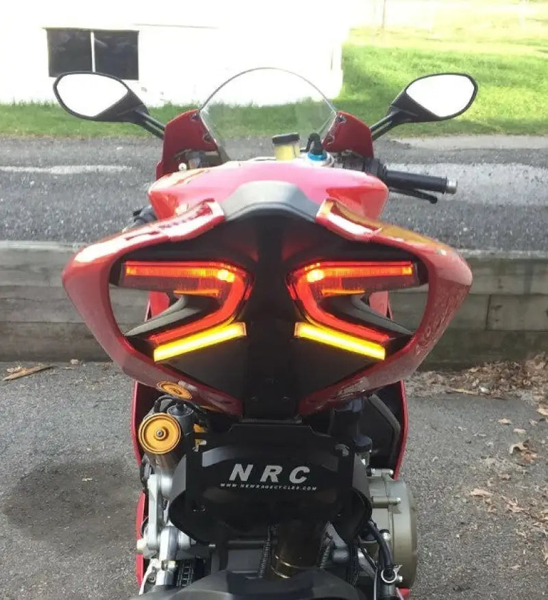 Red sport motorcycle with glowing LED taillights and 1299-FE Fender Eliminator Duc
