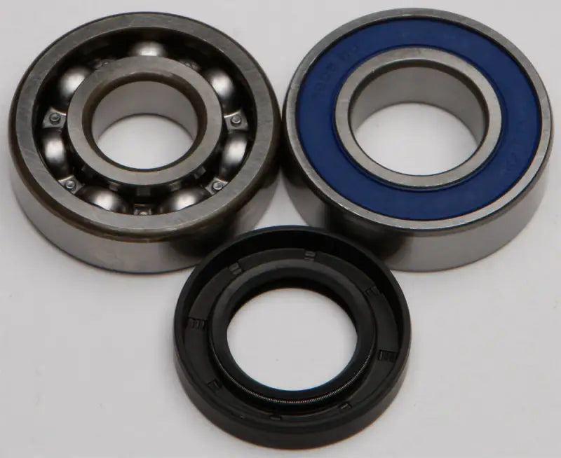 Two ball bearings and an oil seal from the 14-1027 Chain Case Bearing & Seal Kit