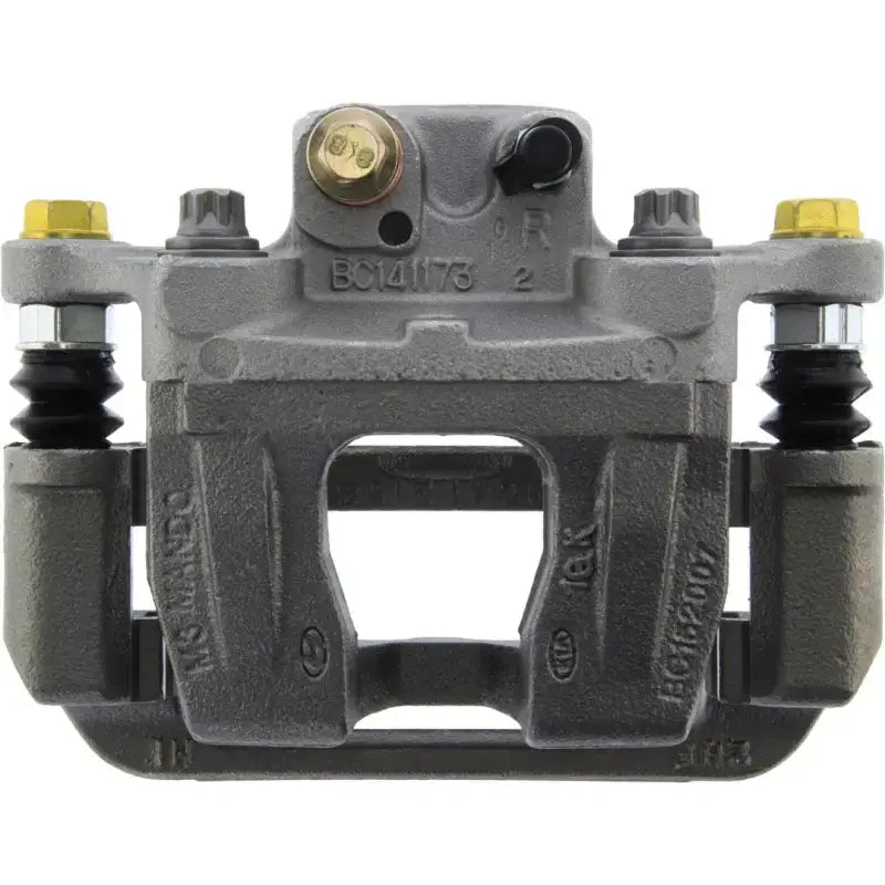 Gray Stop Tech semi-loaded brake caliper with gold bolts for quality braking performance
