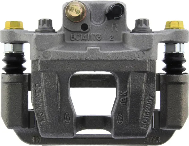 Gray Stop Tech semi-loaded brake caliper with gold bolts for quality braking performance