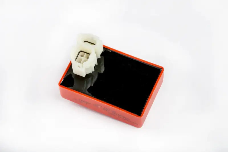 Red and black CDI box with white connectors for Powersports RV parts & accessories