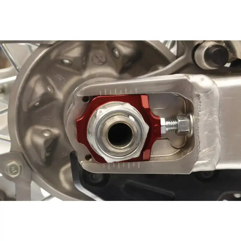 Motorcycle rear axle assembly with 17-205 Axle Blocks Elite Hon Red for enhanced fit