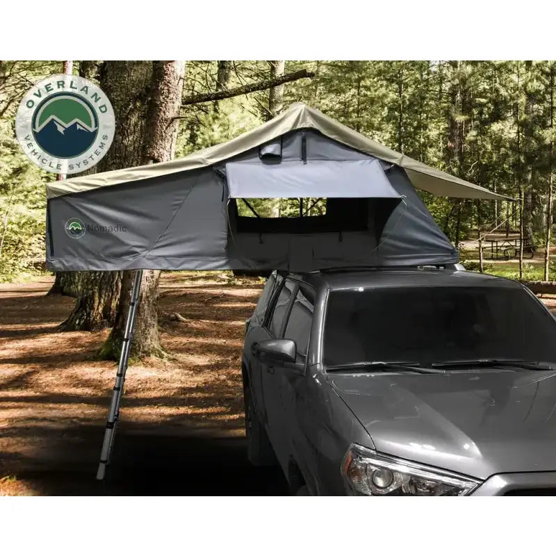 Roof-mounted camping tent with ladder on Overland Vcl Nomadic extended roof top tent