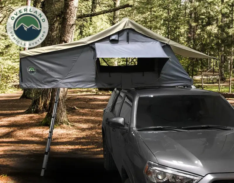 Roof-mounted camping tent with ladder on Overland Vcl Nomadic extended roof top tent