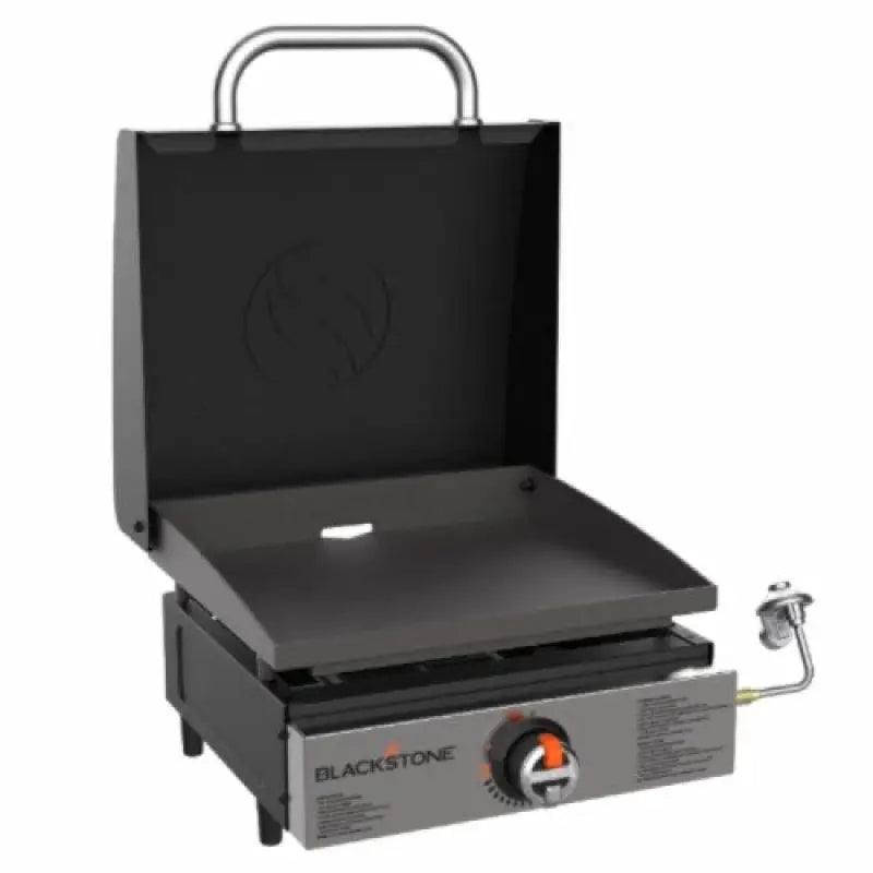 Black griddle with lid for cooking area, perfect for making delicious meals