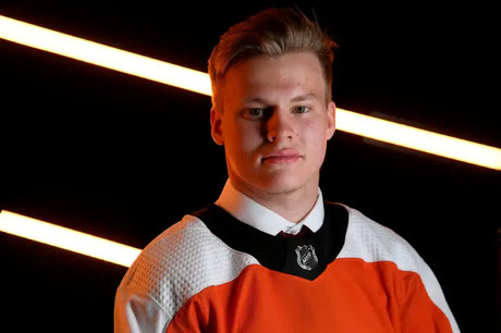 Young male hockey player in orange and white jersey wearing 182-120-orange straightline rugged wing Pol