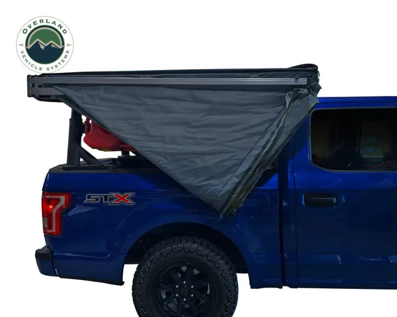 Blue pickup truck with 18379909 Overland VCL Nomadic 270 LT awning attached