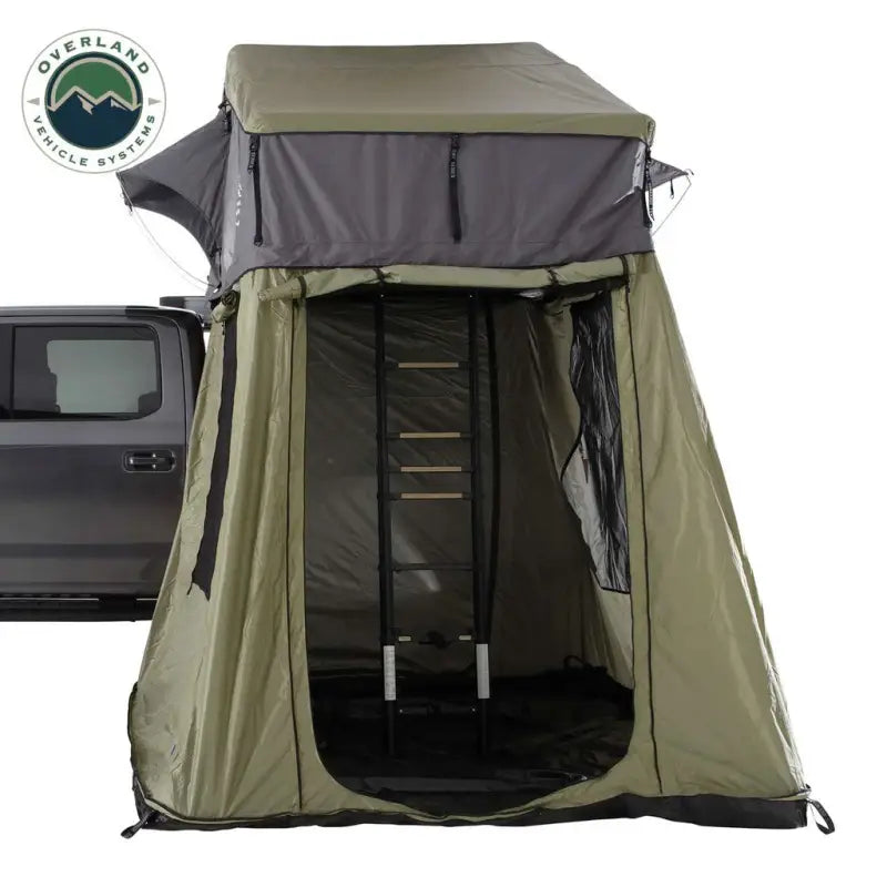 18539936 Overland Vcl N3E Nomadic 3 Extended Roof Top Ten attached to vehicle, featuring spacious design and durable construction for enhanced comfort and weather resistance during outdoor adventures, with ladder for secure entry.