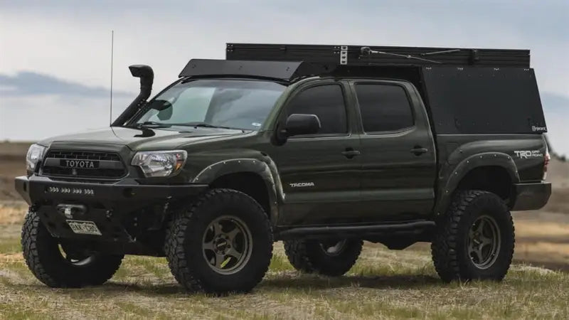 Modified green Toyota Tacoma with Sherpa Equip Animas Camper installed on Tacoma Camper