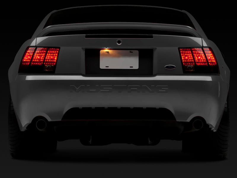 Raxiom 49080 Raxiom 99-04 Ford Mustang Excluding 99-01 Cobra Tail Lights- Black Housing (Smoked Lens)