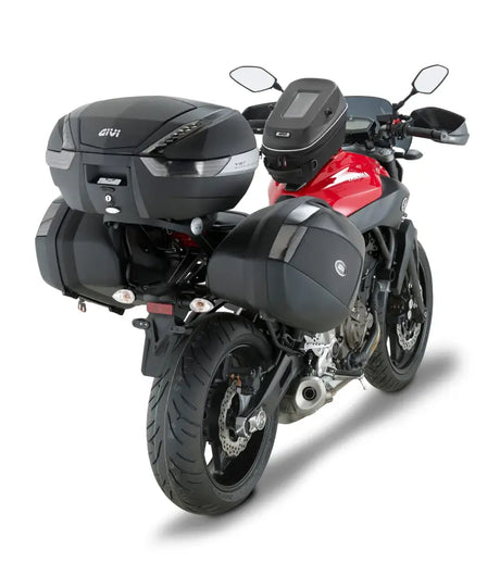 Red and black motorcycle with matte black hard luggage mounting hardware and touring gear