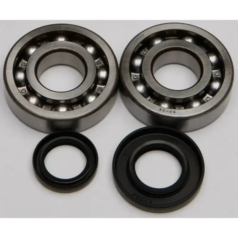 Two metal ball bearings and black rubber oil seals from the 24-1046 Crankshaft Bearing Seal Kit for RV parts & accessories