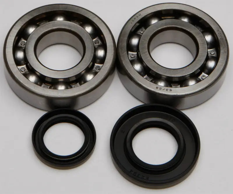 Two metal ball bearings and black rubber oil seals from the 24-1046 Crankshaft Bearing Seal Kit for RV parts & accessories
