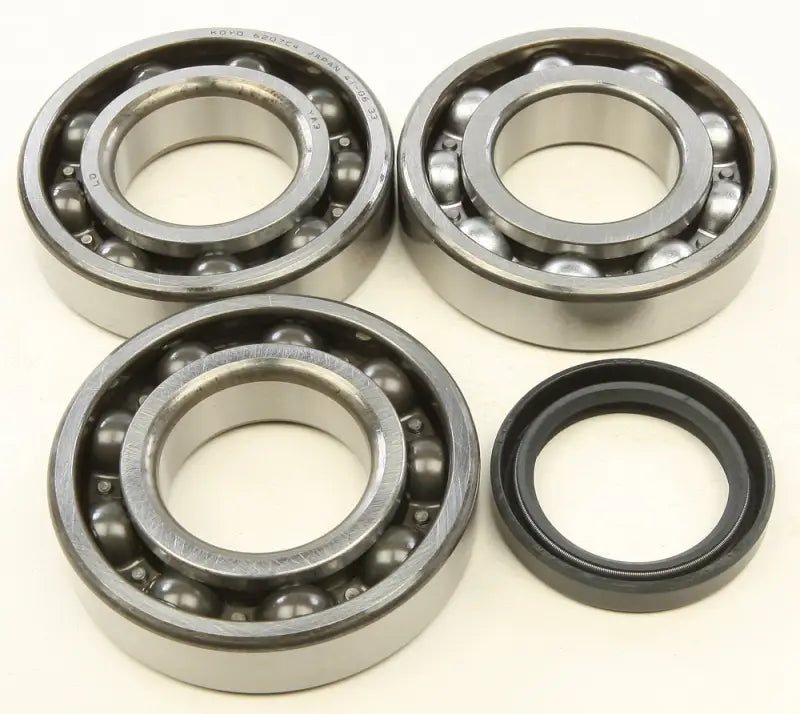 Three ball bearings and an oil seal from the 24-1090 crankshaft bearing kit