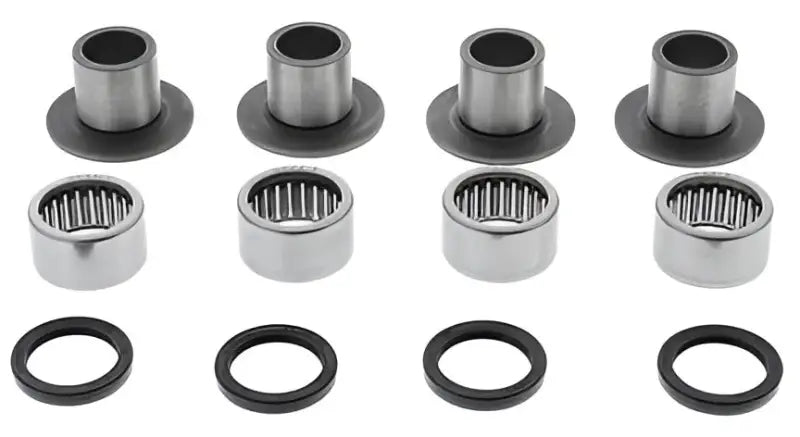 Four sets of metal bearings bushings and seals in a Swingarm Bearing Kit for easy repair