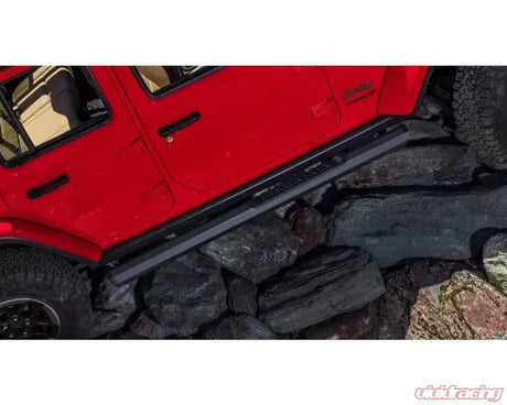 Red off-road vehicle with Maxway Octa Series Step Bar and rock sliders
