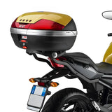 Motorcycle top case with red gold accents, matte black hard luggage mounting hardware