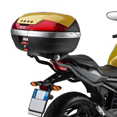 Motorcycle top case with red gold accents, matte black hard luggage mounting hardware