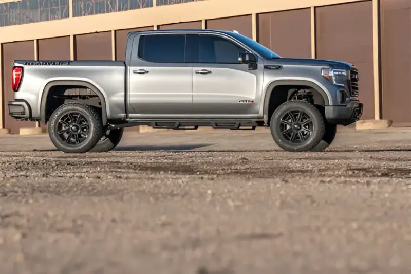Silver lifted pickup truck with Readylift 6 inch big lift kit and rear Falcon shocks