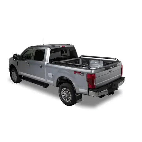 Silver pickup truck with bed rails.