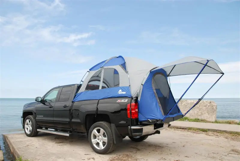 Blue and gray Napier Ent Sportz truck tent on black pickup bed