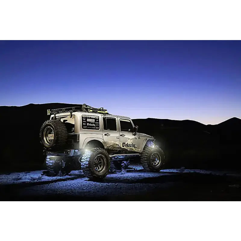 Silver off-road Jeep showcasing the 5875-001 Oracle Light Wheel Well Rock Light Kit Wht 4Pc