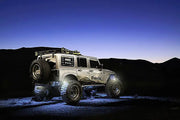 Silver off-road Jeep showcasing the 5875-001 Oracle Light Wheel Well Rock Light Kit Wht 4Pc