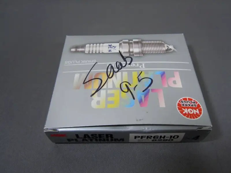 6290 NGK Pfr6H-10 spark plug box (4 pieces) on a gray background, displaying NGK Laser Platinum branding and "Saab 9-3" written on the box.