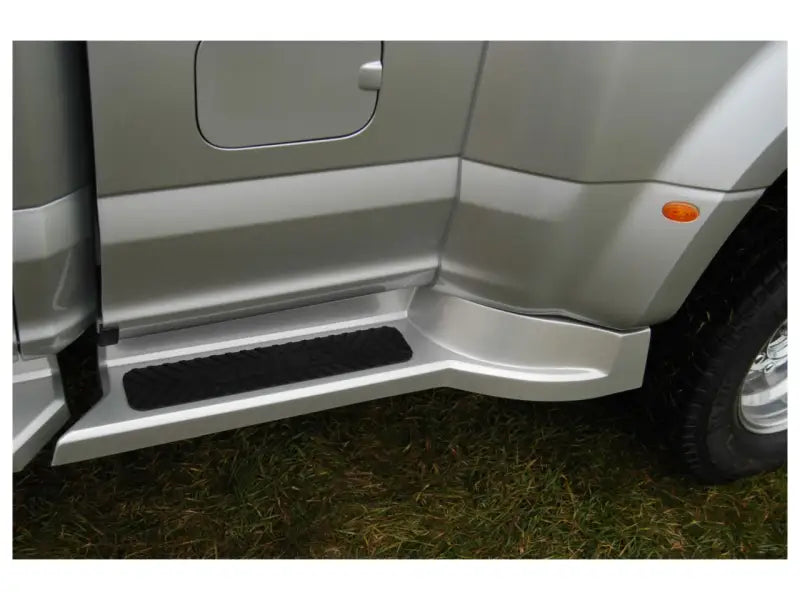 Silver Ford Transit with roof rack and side step for carrying oversized equipment