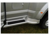 Silver Ford Transit with roof rack and side step for carrying oversized equipment