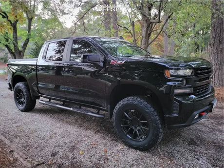 Black truck equipped with 69-39400 Readylift 4.0'' Sst Lift Kit, showcasing increased ground clearance and larger tires for off-road capability and aggressive stance, Suspension, AVADA - Best Sellers, Must Haves