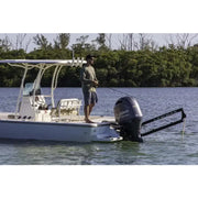 Fishing boat with a man using Lewmar Axis shallow water anchor in action