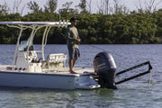 Fishing boat with a man using Lewmar Axis shallow water anchor in action