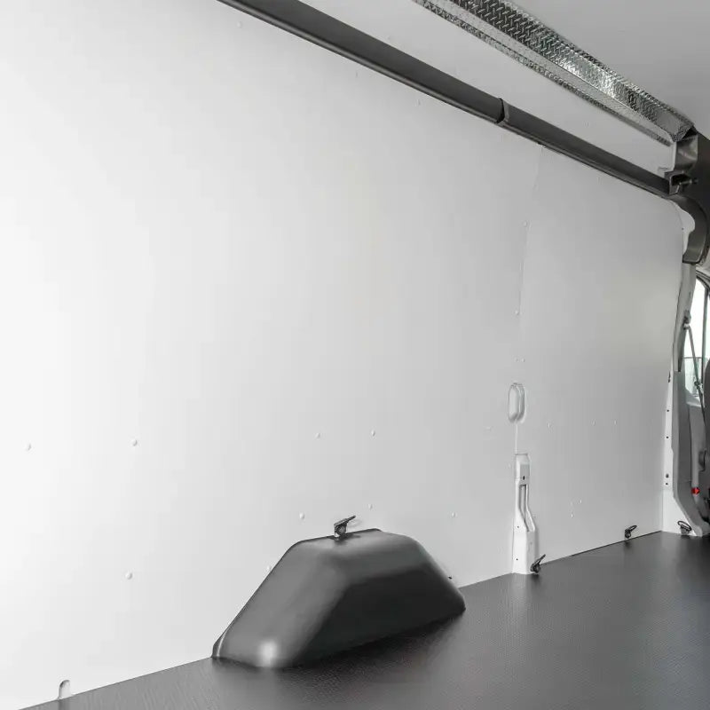 Van interior with white walls and black floor showcasing Legend Fleet Duratherm wall liner