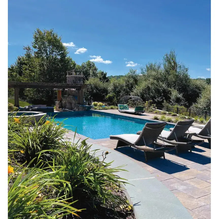 Outdoor swimming pool with stone waterfall, lounge chairs, perfect for Spike Rear Windshield tint