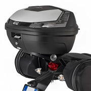 Black matte black motorcycle top case with integrated lights and luggage mounting hardware
