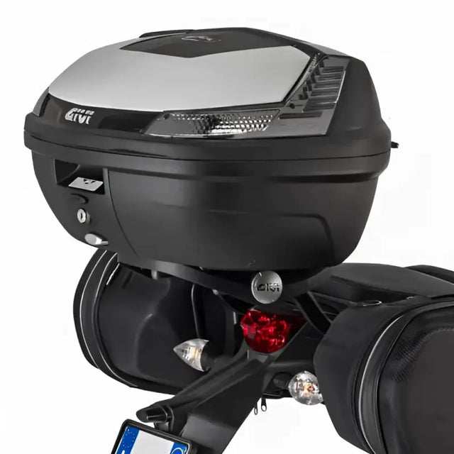 Black matte black motorcycle top case with integrated lights and luggage mounting hardware