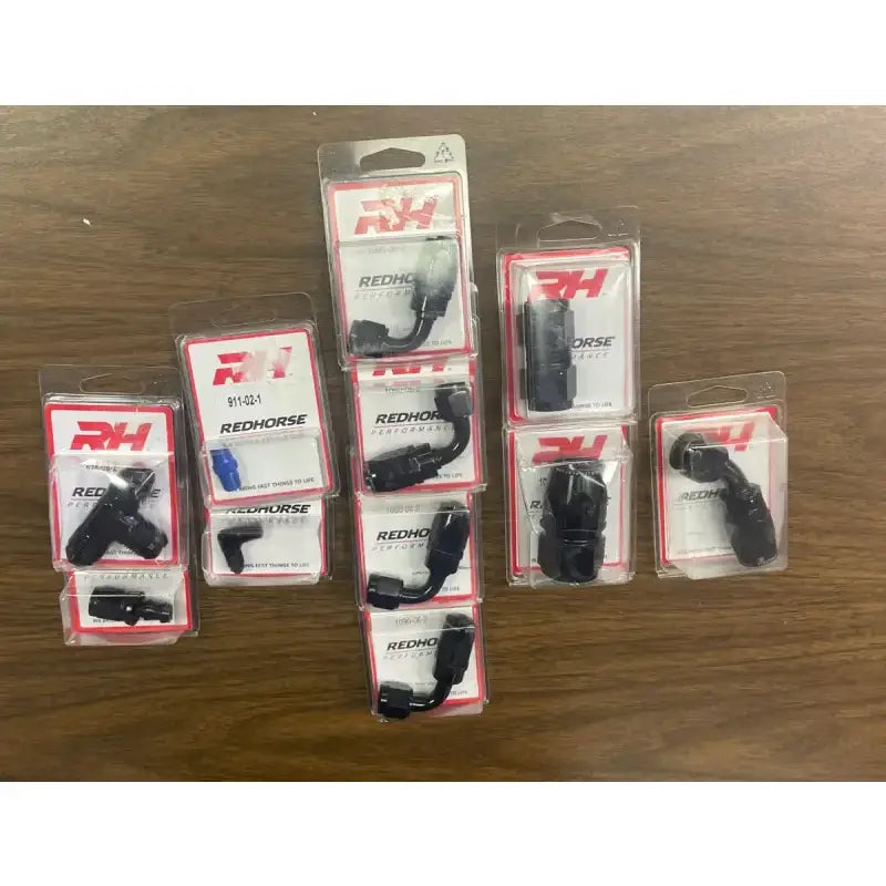 Redhorse Performance 824-08-2 AN to NPT Tee fitting in packaging on a wooden surface.