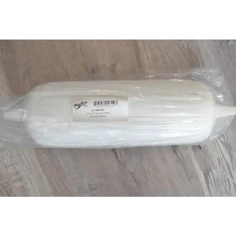 Polyform 83-408-891 5.5' X 19' Twin Eye Fender packaged in plastic wrap, placed on a wooden surface.
