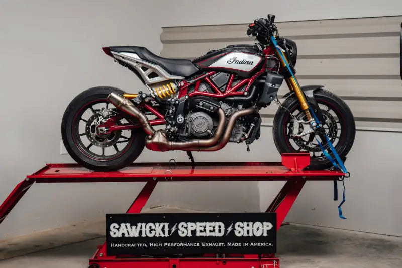 Red and black Indian Motorcycle with gold accents on lift for Sawicki FTR slip RV parts