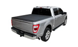 Silver pickup truck with black lomax bed cover and running boards on ram classic