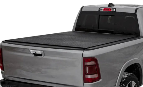 Silver pickup truck with black Lomax trifold bed cover for Ram Classic 5ft 7in