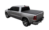 Silver pickup truck with access lomax tri-fold cover on 09-18 Ram 1500 bed