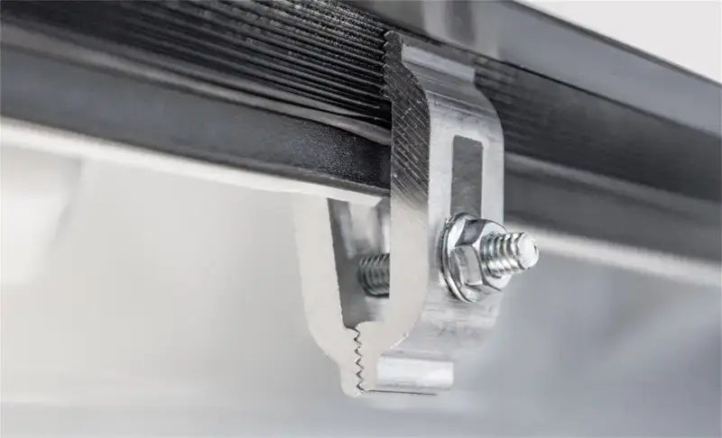 Metal solar panel mid-clamp on Access LOMAX tri-fold cover for Ram 1500 bed