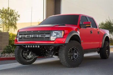 Red Ford Raptor pickup with Addictive Desert Designs ADD PRO Front Bumper