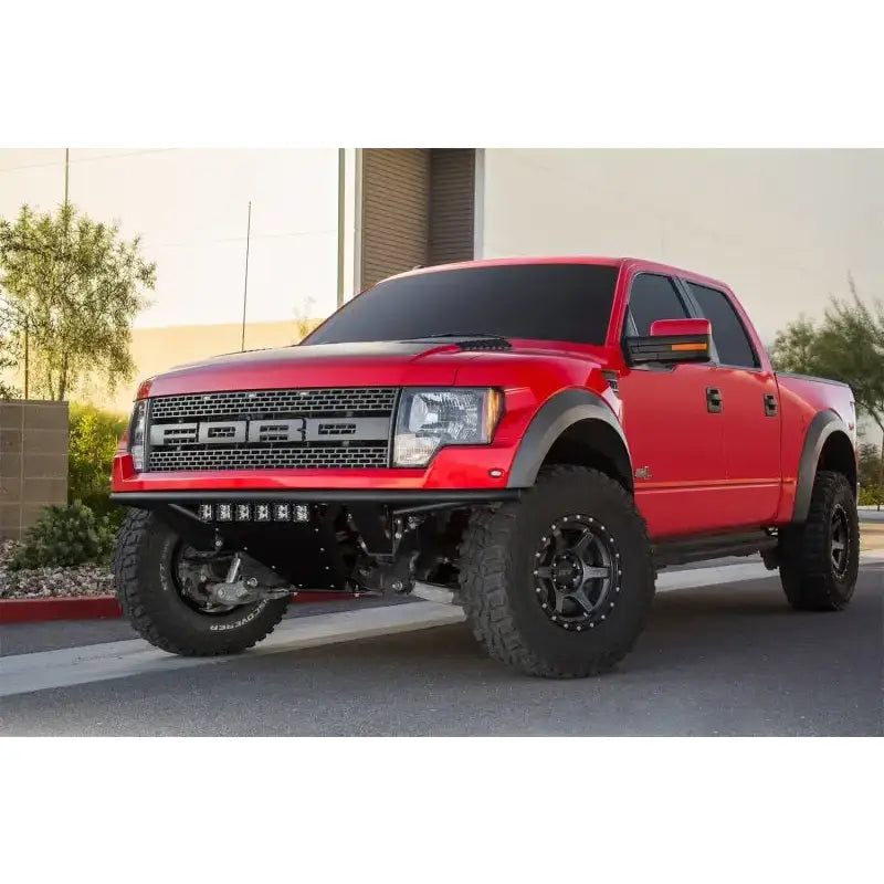 Red Ford Raptor pickup with Addictive Desert Designs ADD PRO Front Bumper